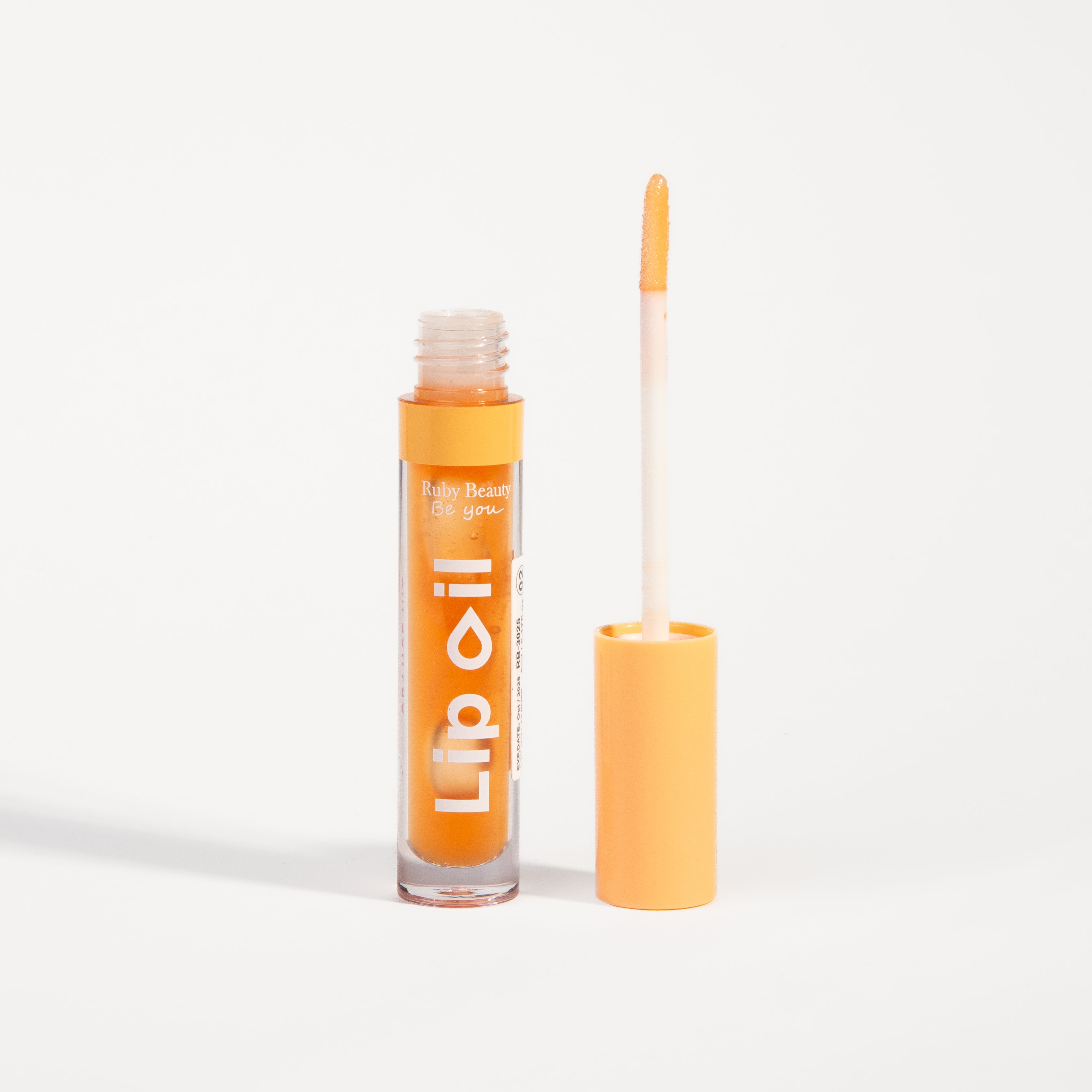 Ruby Beauty Lip Oil in Orange Hit β wand applicator showing gloss