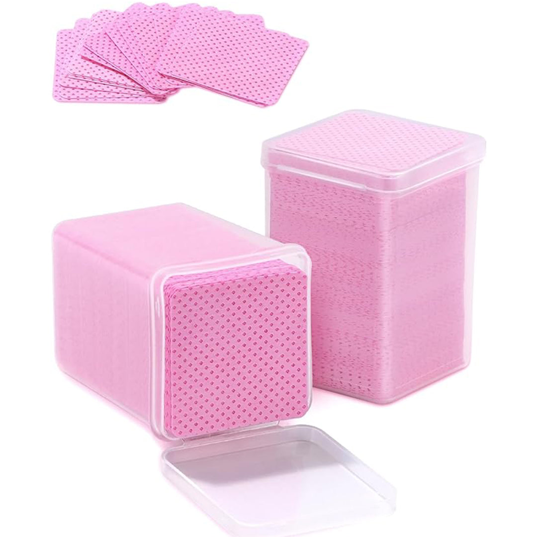 Open container of Ruby Beauty pink lint-free nail wipes, showing multiple square wipes stacked neatly.