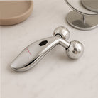 Ruby Beauty 3D Massager on marble table for facial and body massage