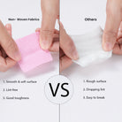Comparison between Ruby Beauty lint-free nail wipes and regular cotton pads, showing smooth texture vs rough texture.